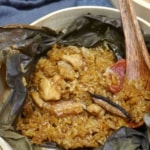 stick rice, chicken, sausage and mushrooms over a lotus leaf with overlay text that says stick rice chicken.