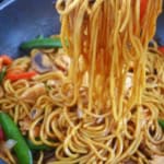 pulling lo mein noodles with chopsticks.