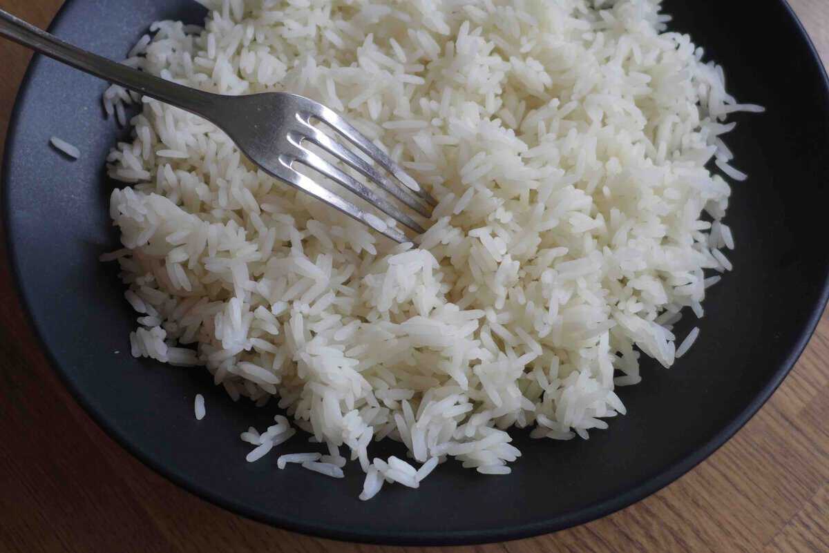 loosening cooked rice with a fork.