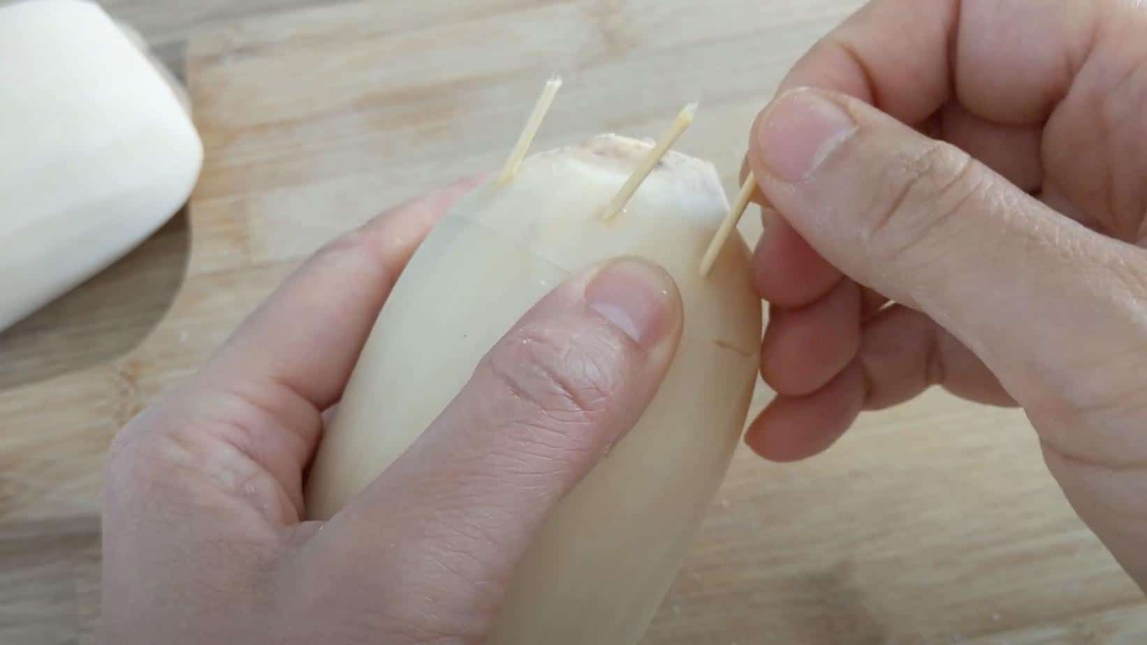 putting toothpick into lotus root