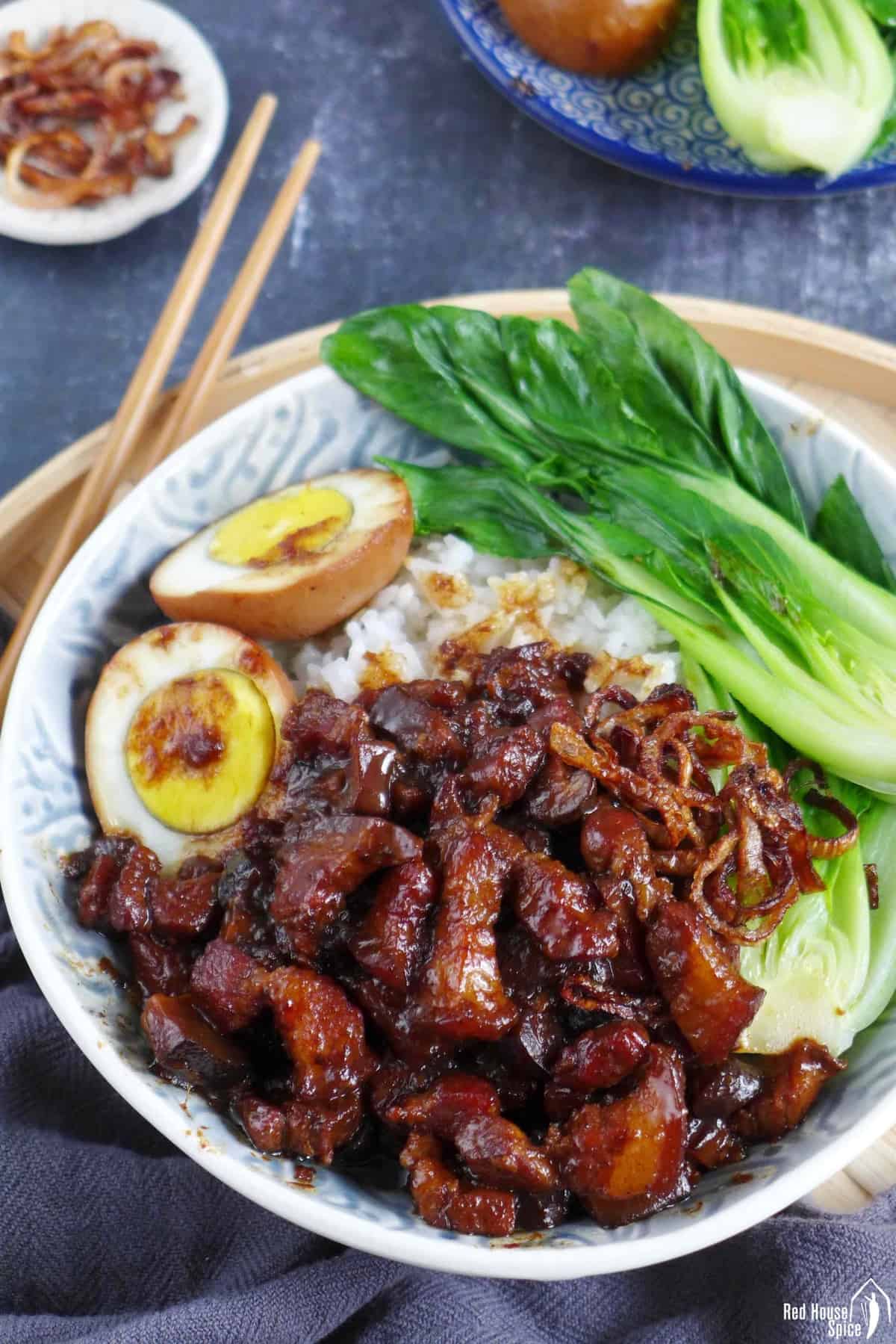 A bowl of Taiwanese Lu Rou Fan consisting of braised pork, hard boiled egg, Bok Choy and rice