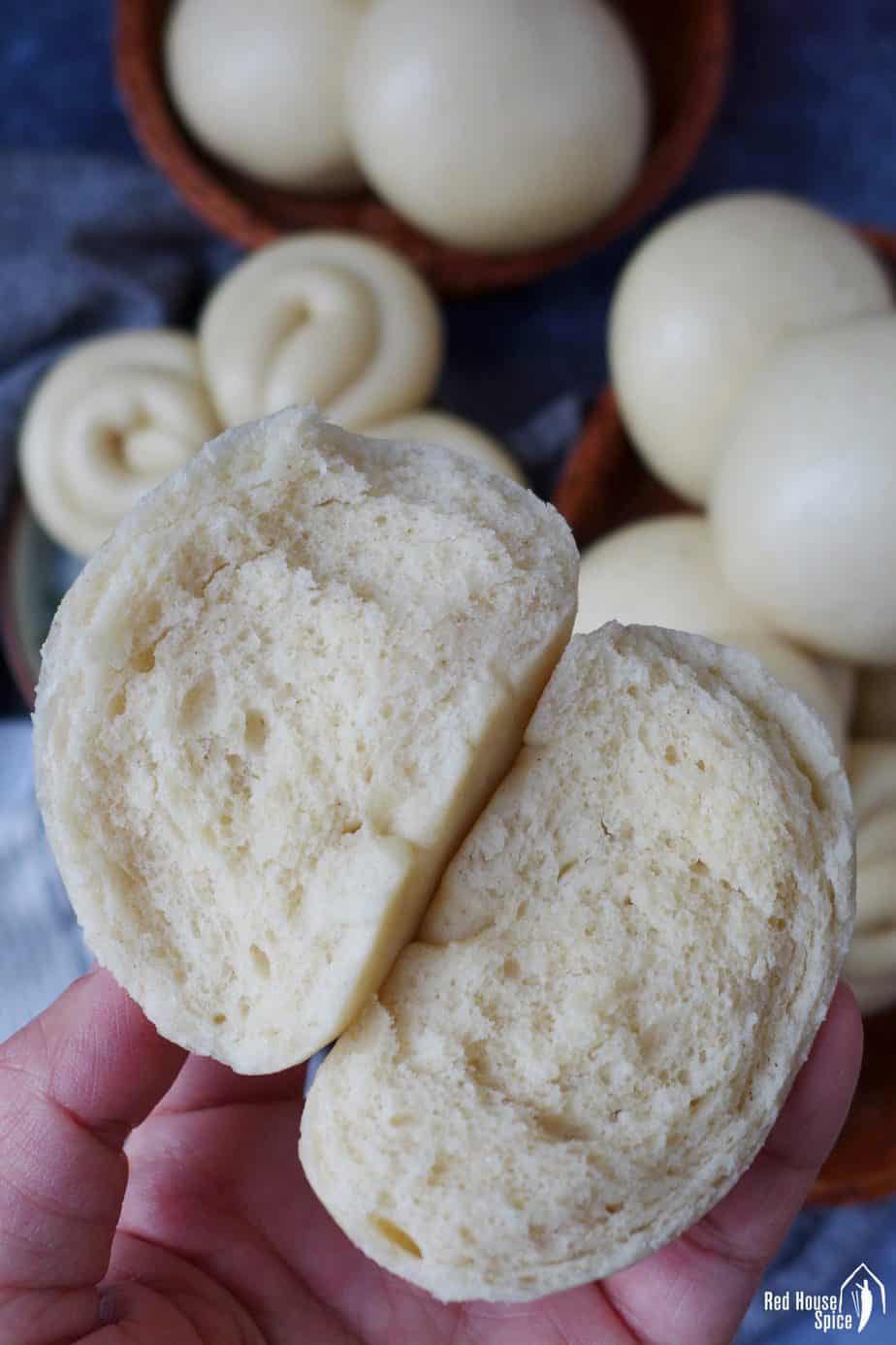 A Chinese steam bun torn into halves.