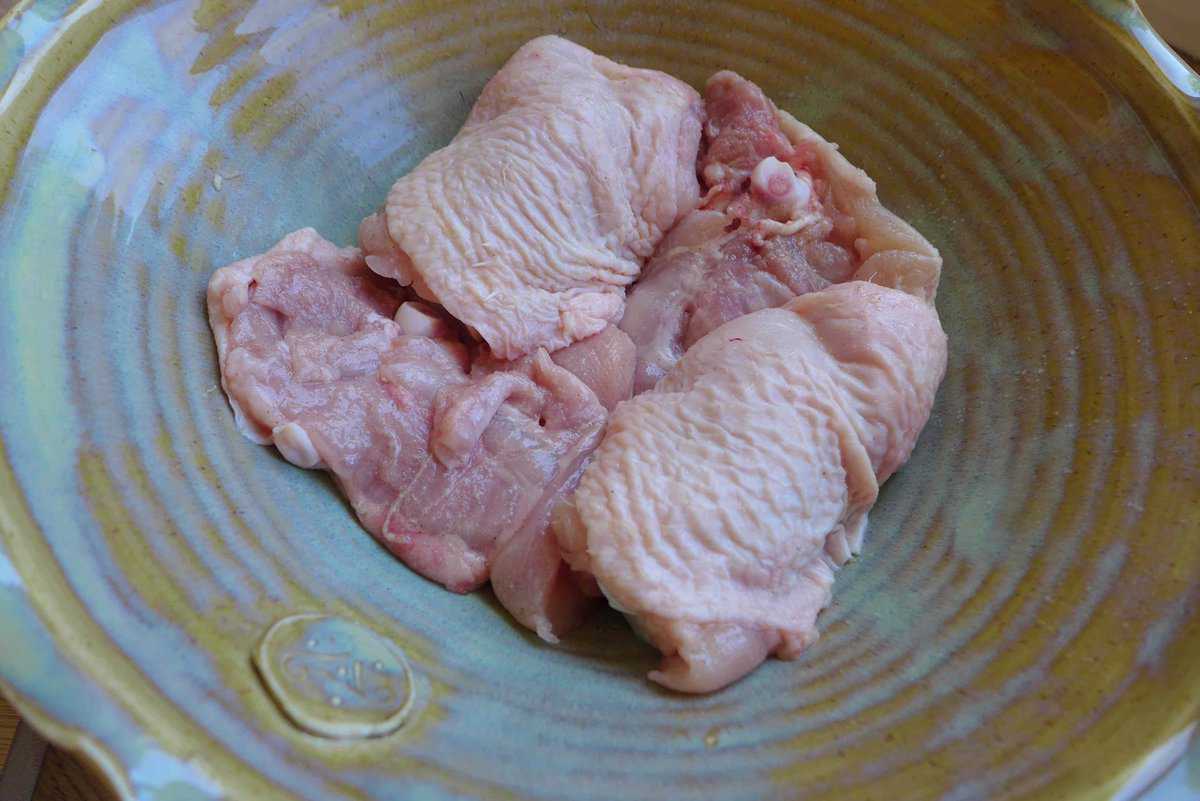 marinating chicken thighs in a bowl