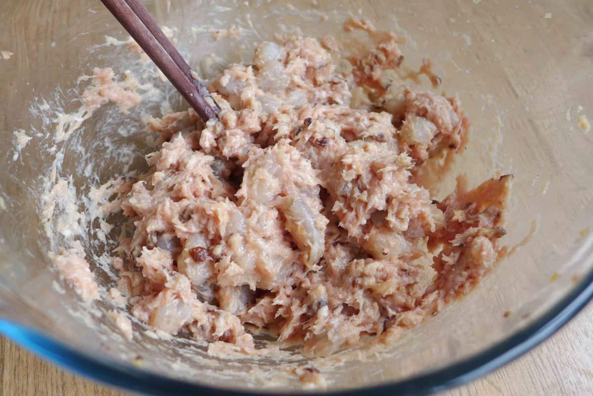mixing Siu Mai filling with chopsticks.