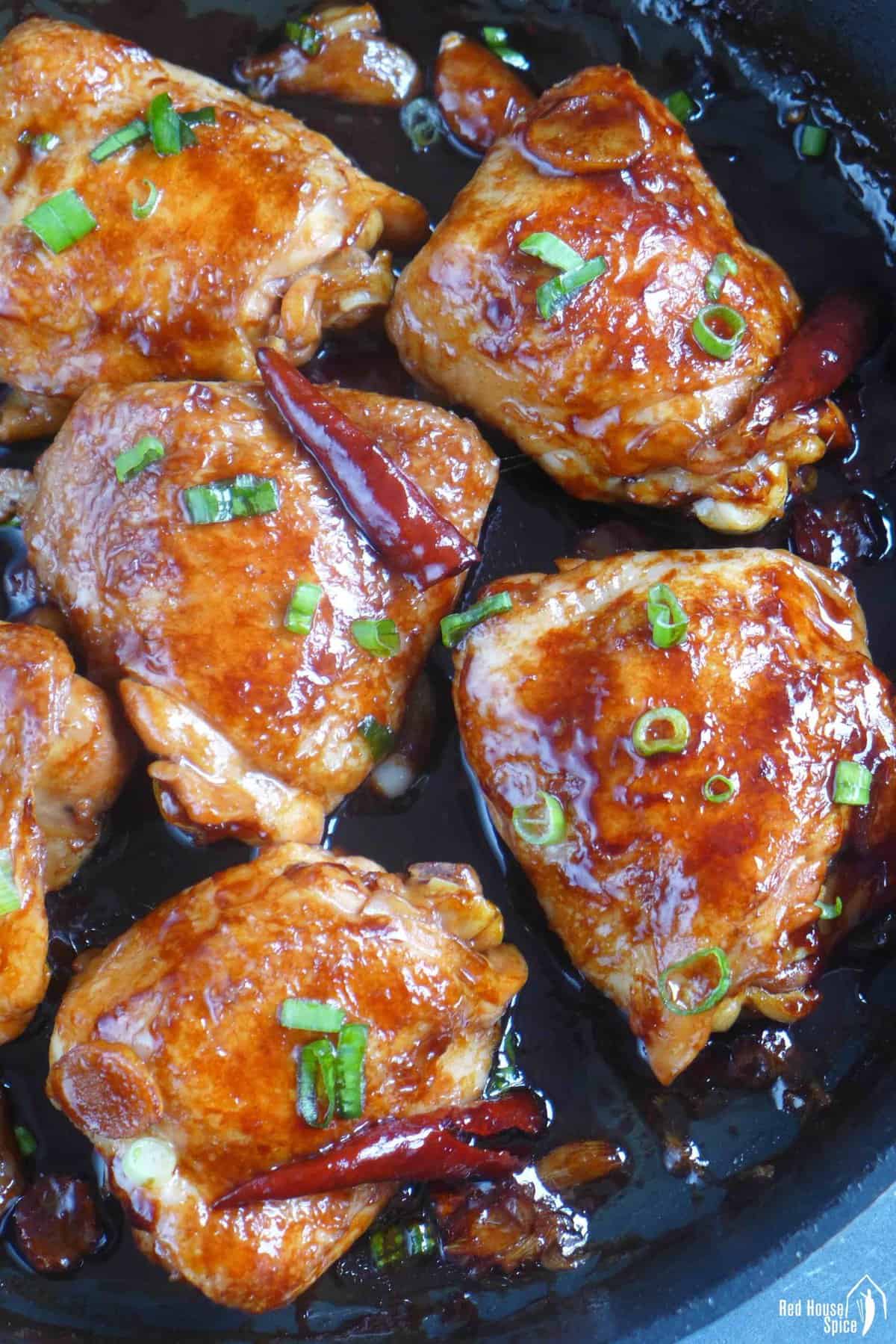 6 oyster sauce chicken thighs in a skillet.
