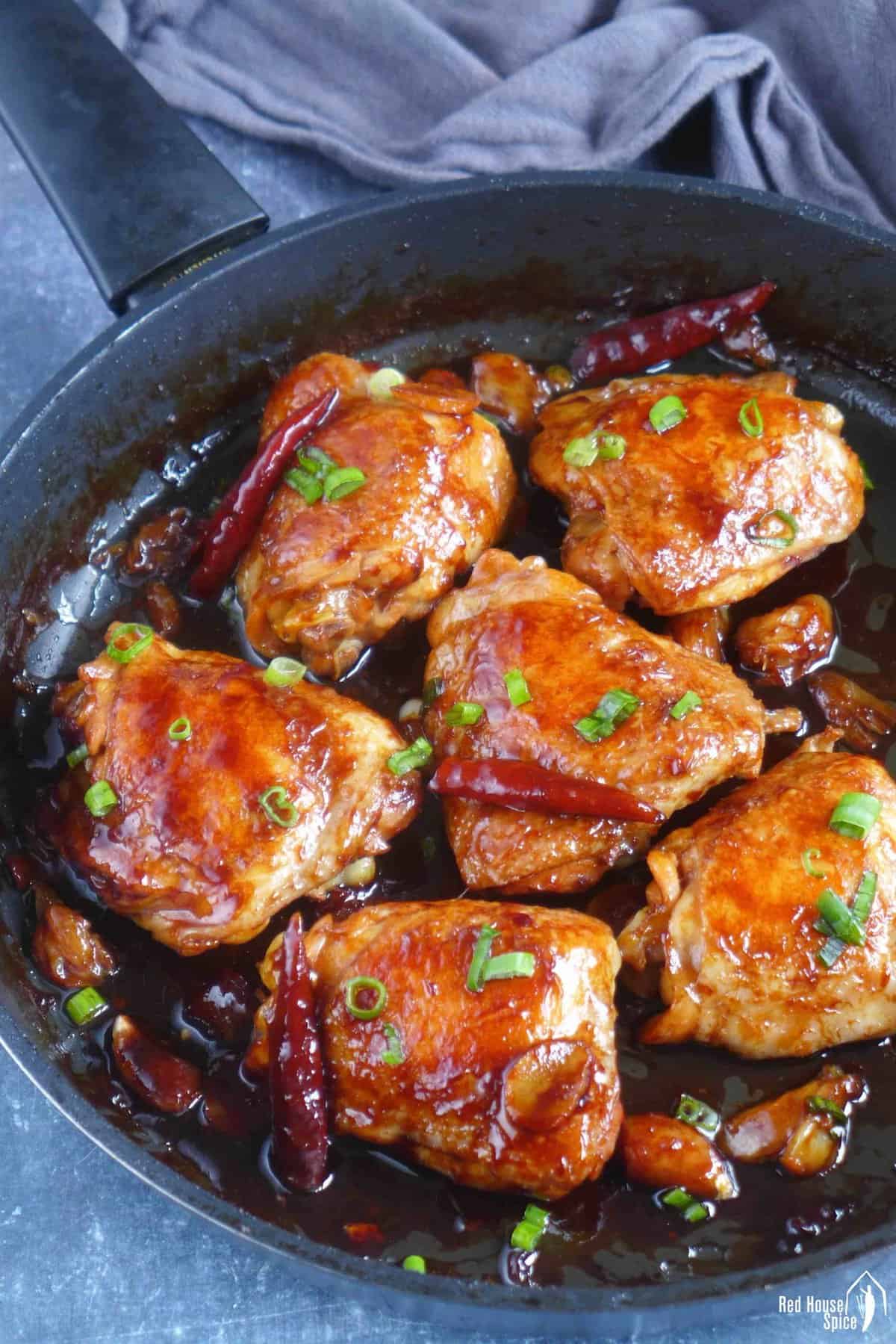6 oyster sauce chicken thighs in a skillet.