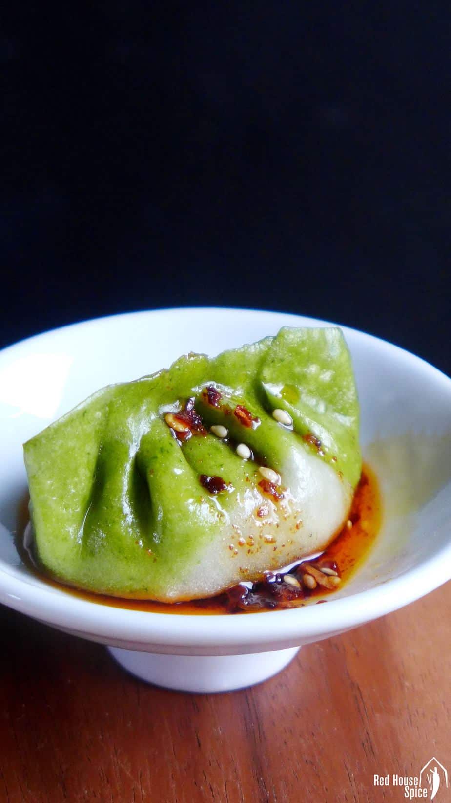 One bi-colour dumpling with chilli oil