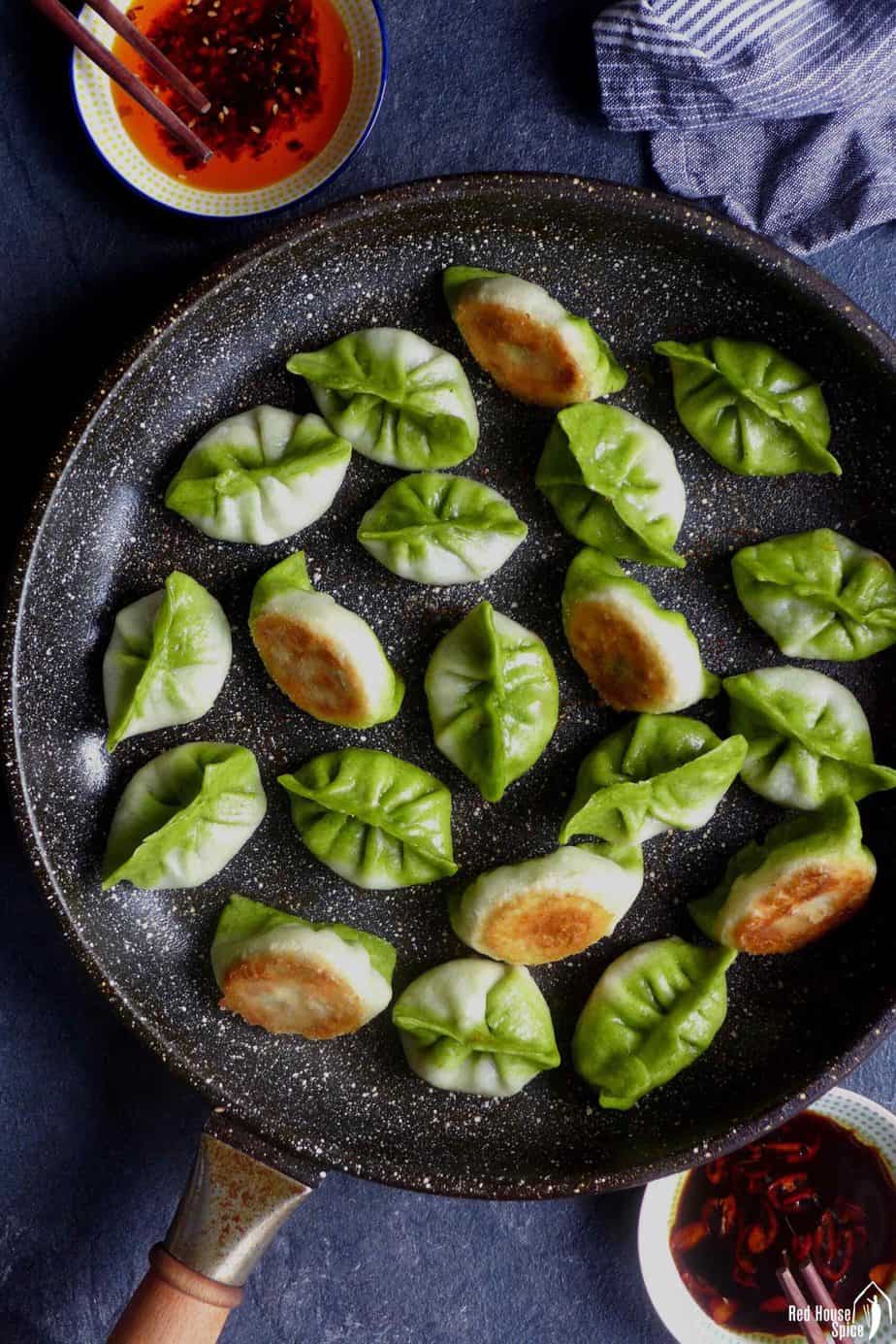Bi-colour vegetarian dumplings in a pan