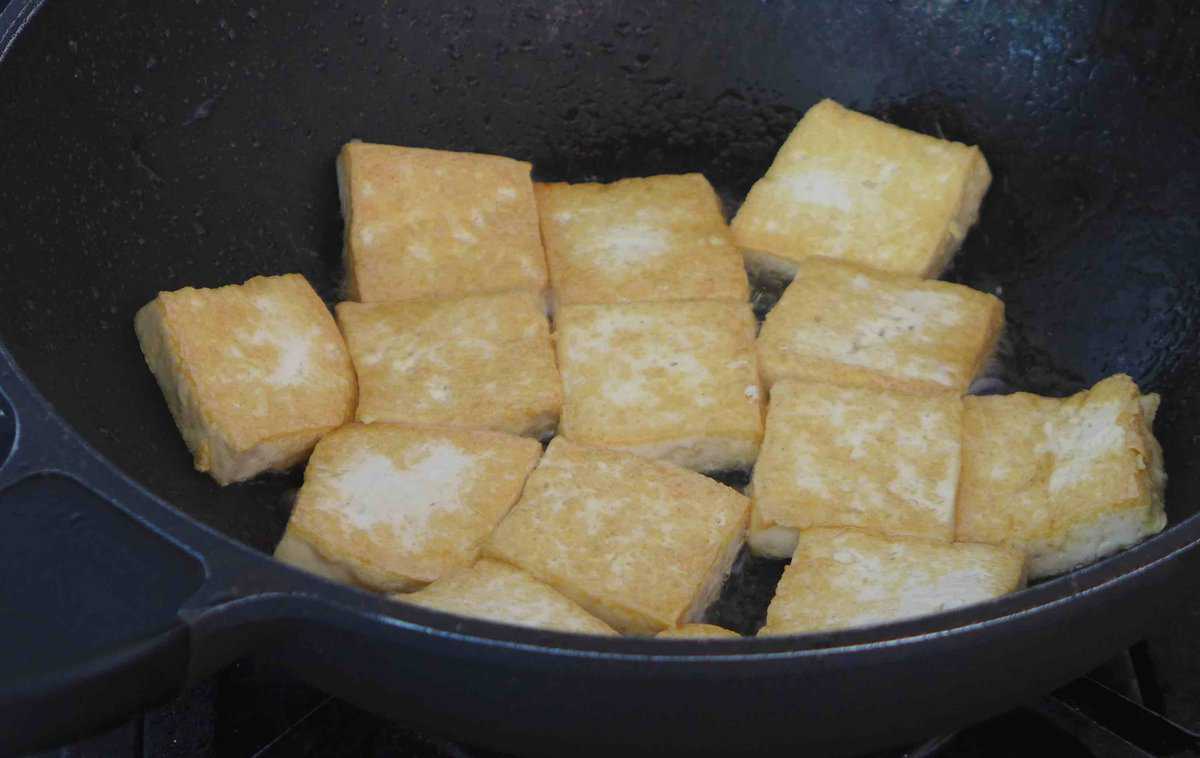 pan frying tofu slices.