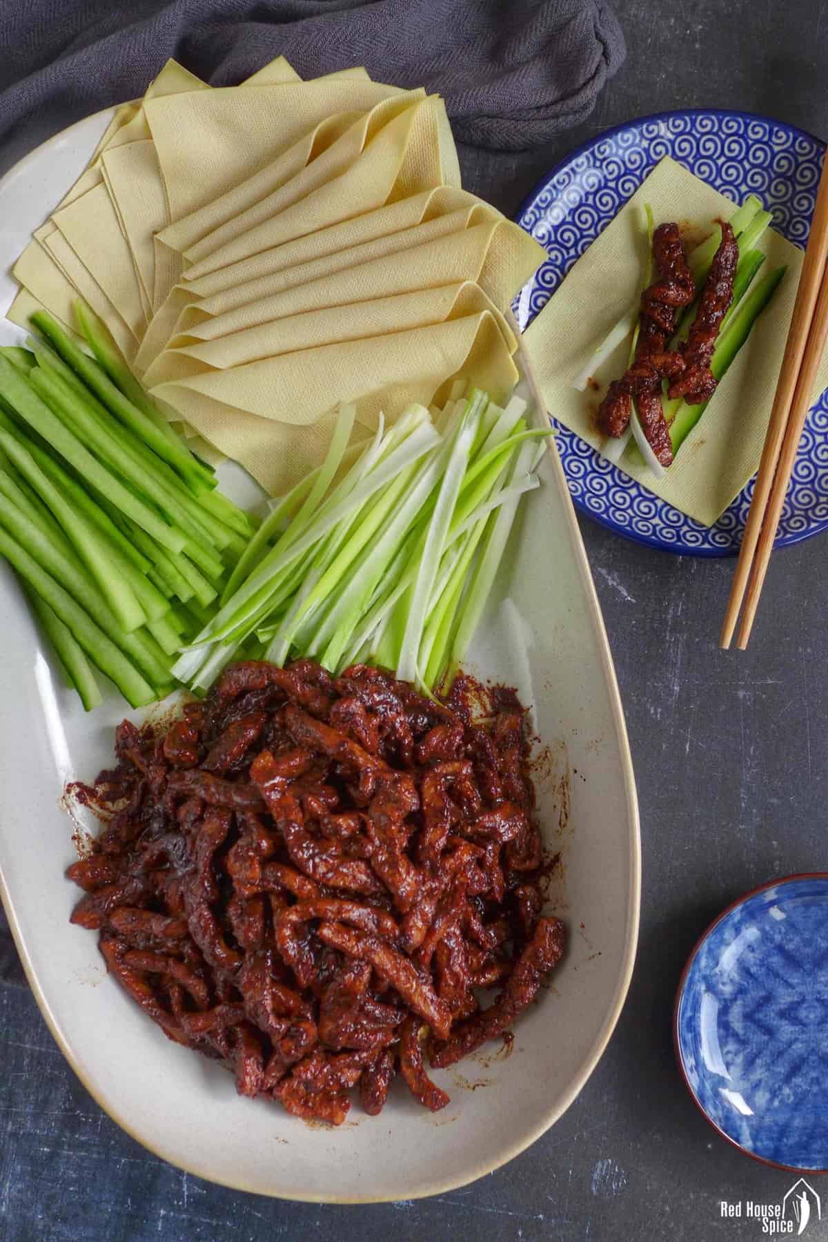 Peking shredded pork with tofu sheets, scallions and cucumber.