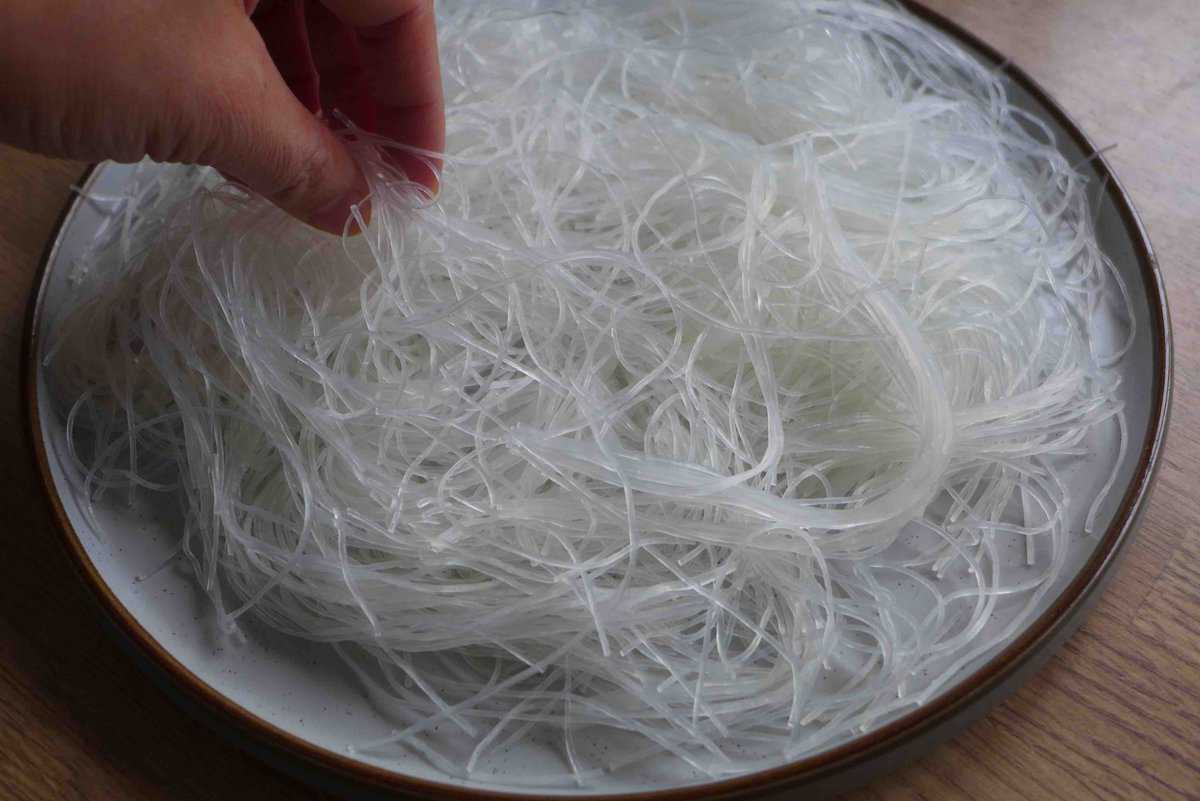 placing rehydrated vermicelli on a plate.