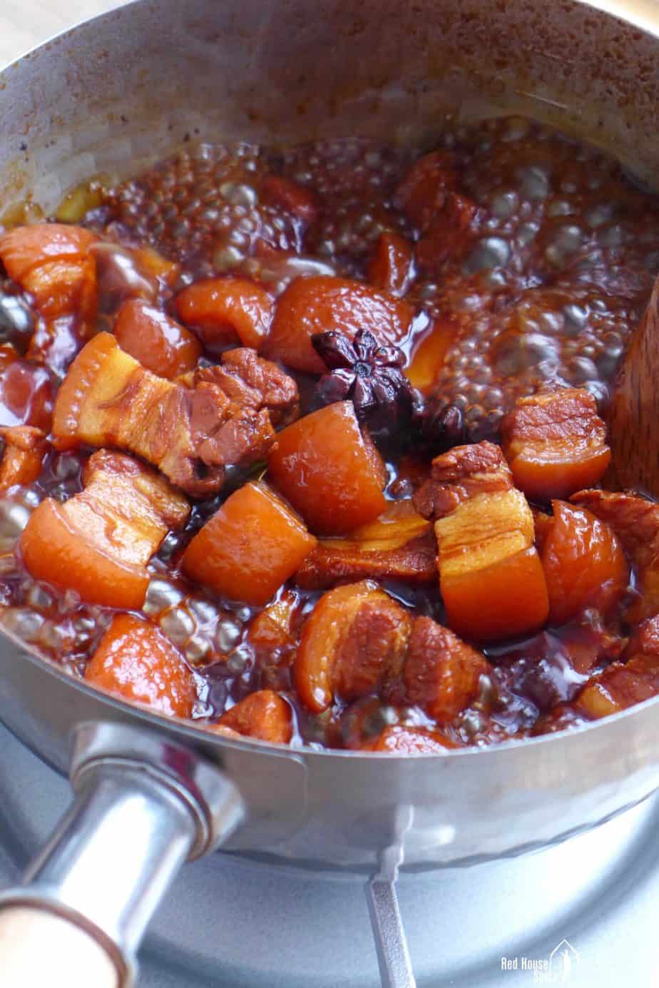 Boiling pork belly in a thick sauce