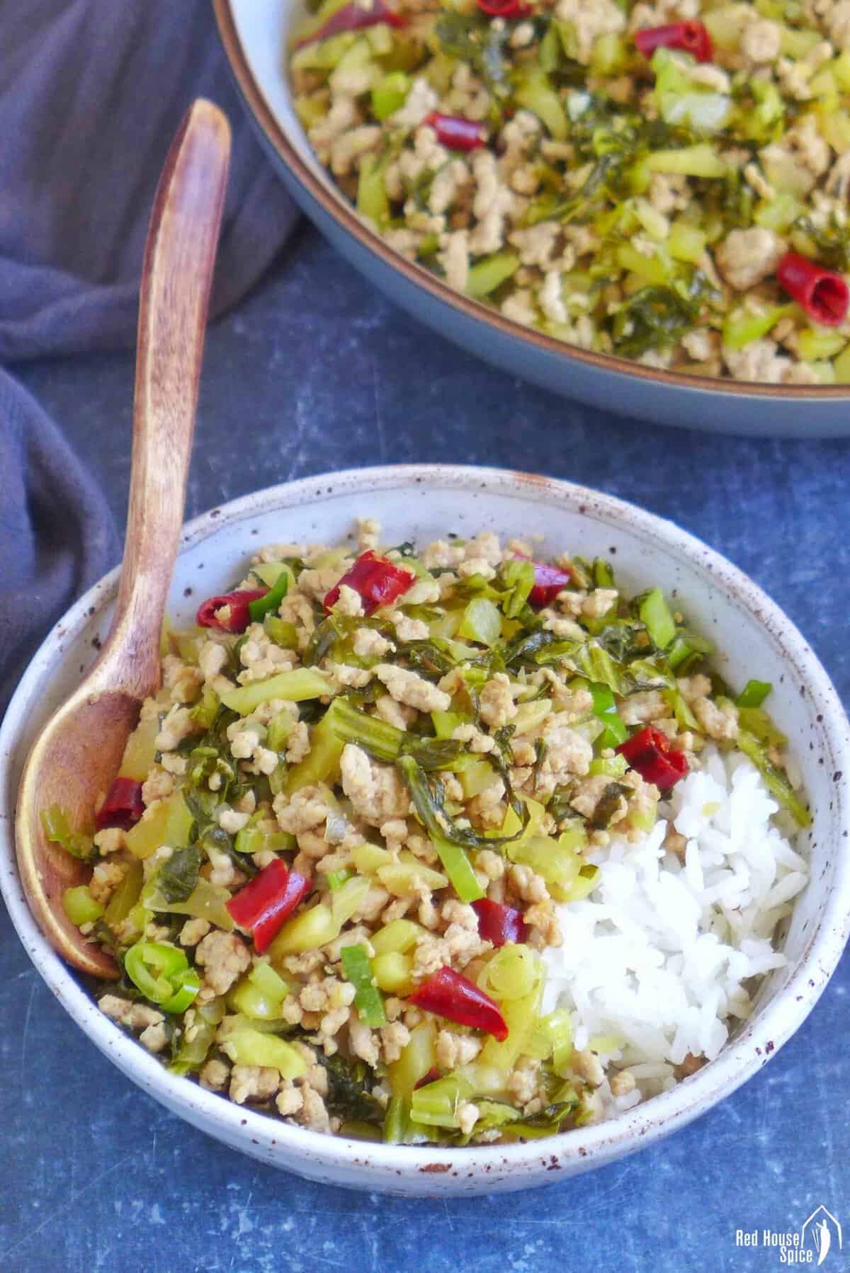 Pork and sour vegetable stir-fry over a bowl of rice.