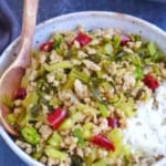 a bowl of pork and sour vegetable stir-fry with overlay text that says pork and pickle stir-fry.