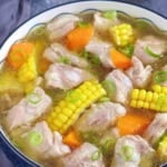 a big bowl of pork rib soup with corn and carrot with overlay text that says chinese pork rib soup.
