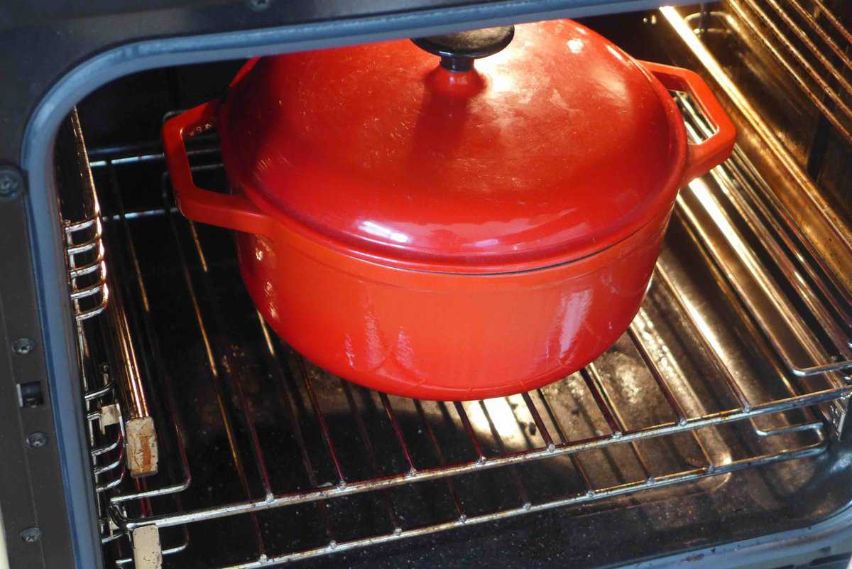 a pot with a lid inside the oven.
