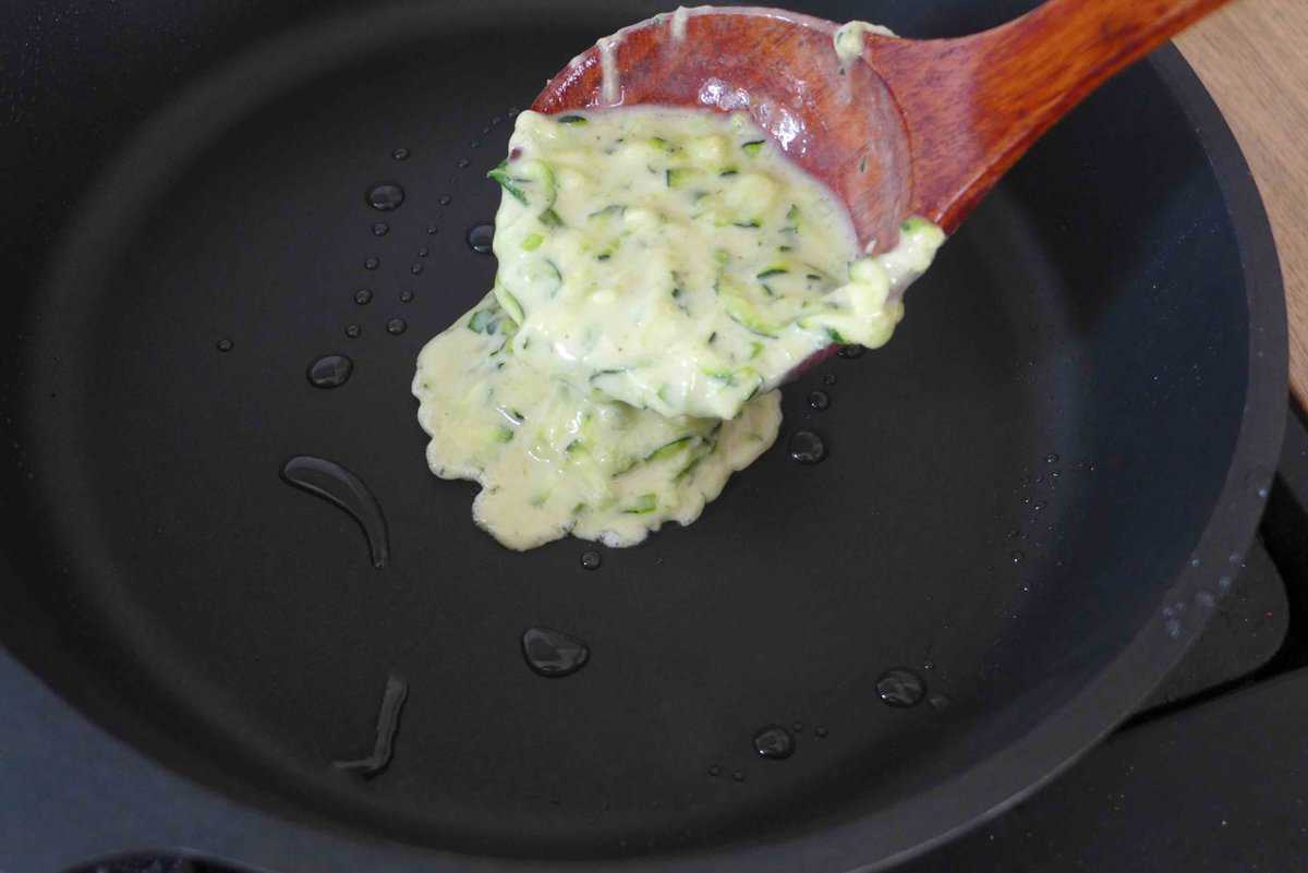 spooning batter into a pan.