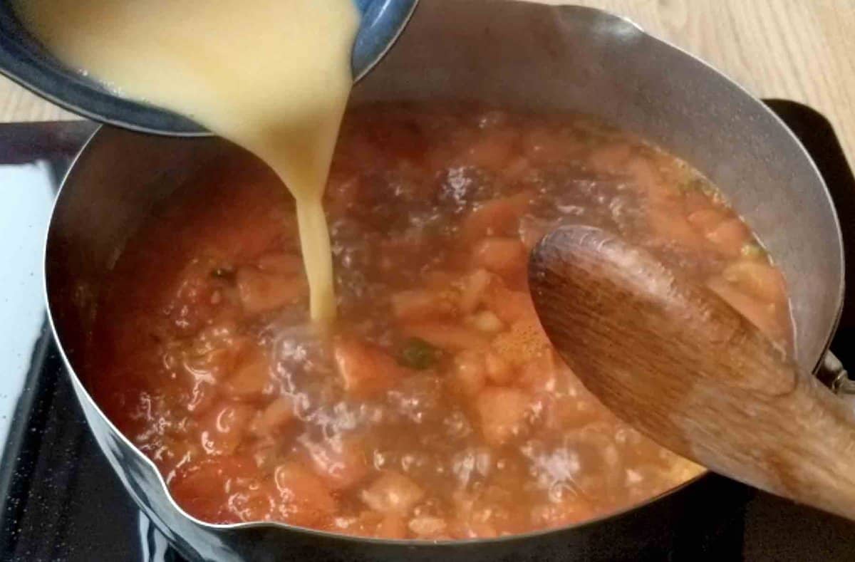 pouring egg in soup.