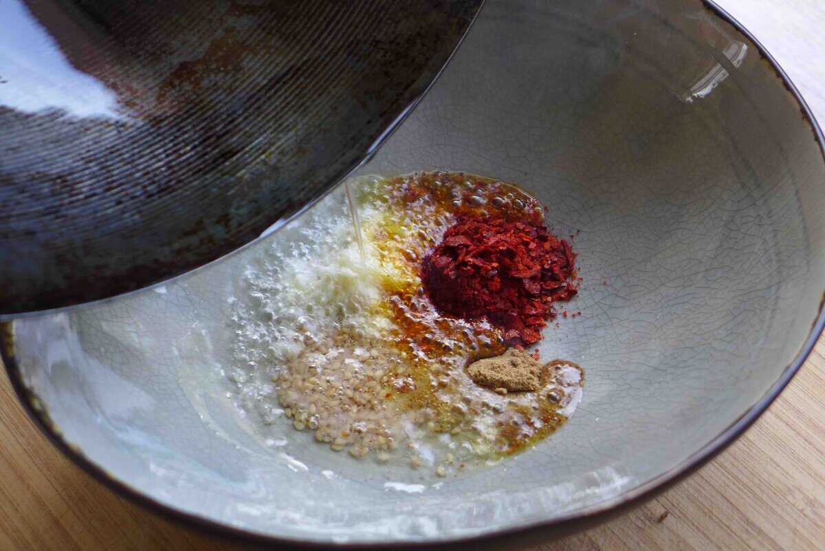 pouring oil over spices.