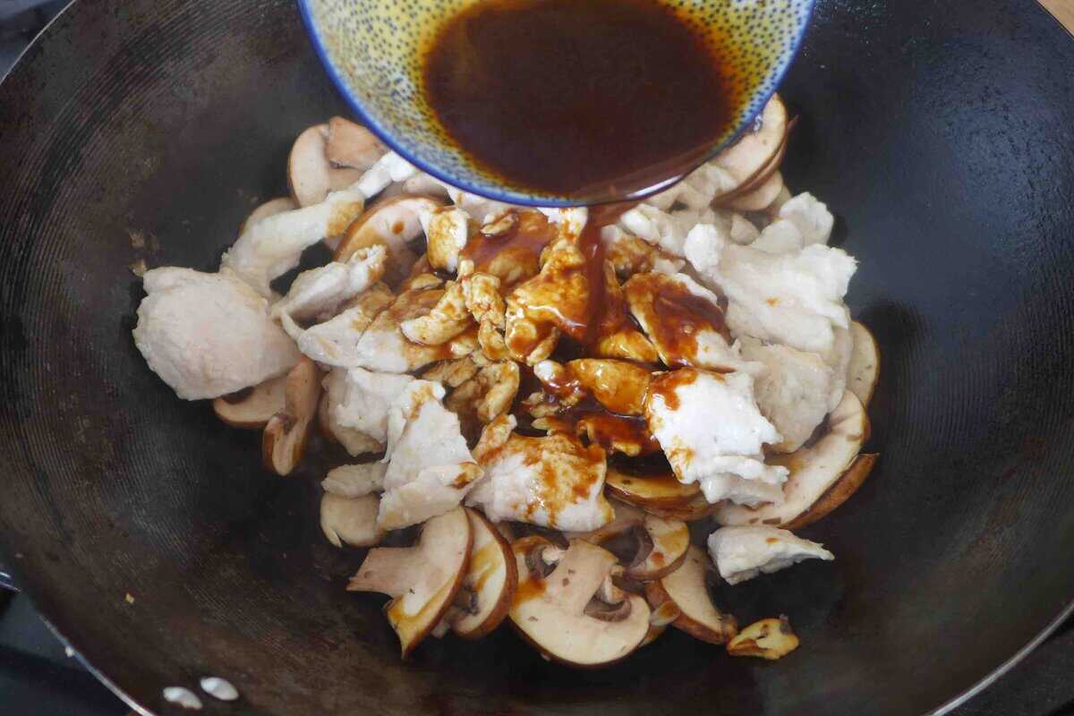 pouring sauce over chicken and mushrooms.
