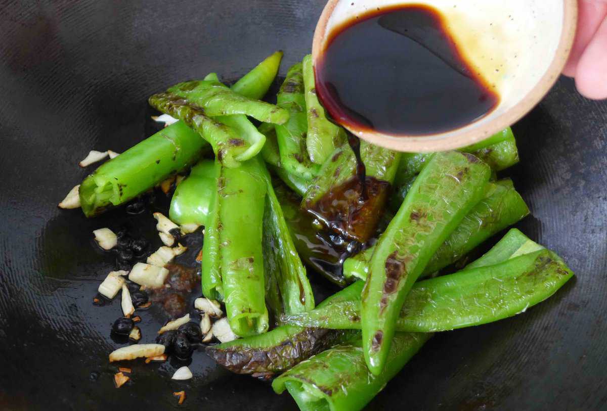 pouring sauce over chili pepper.