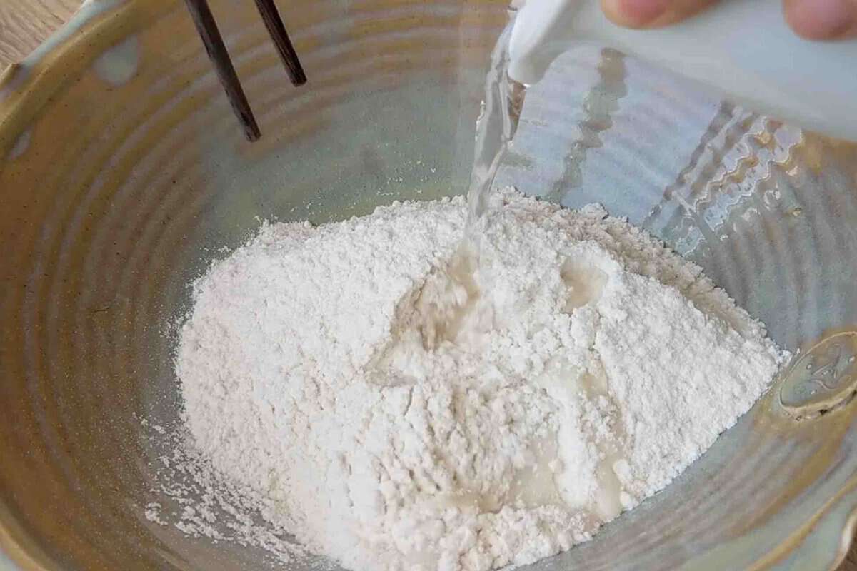 adding water to flour.