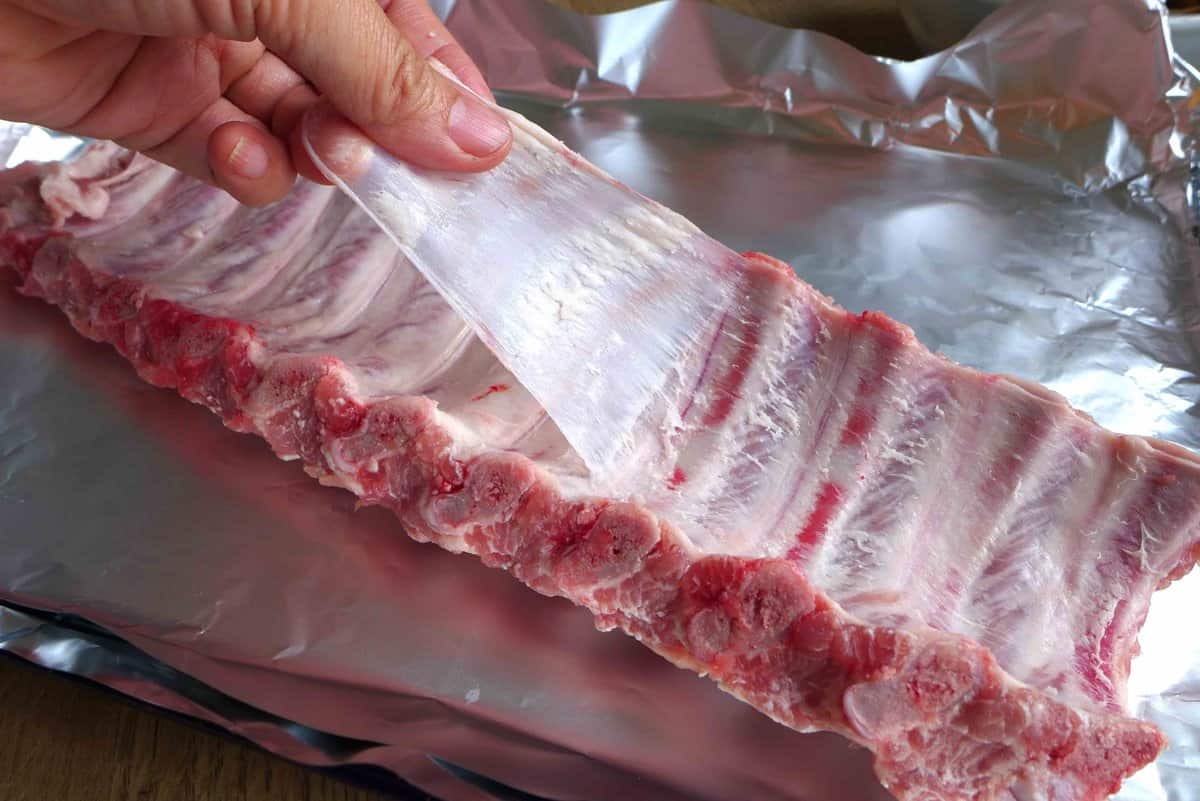 pulling the membrane off the ribs.
