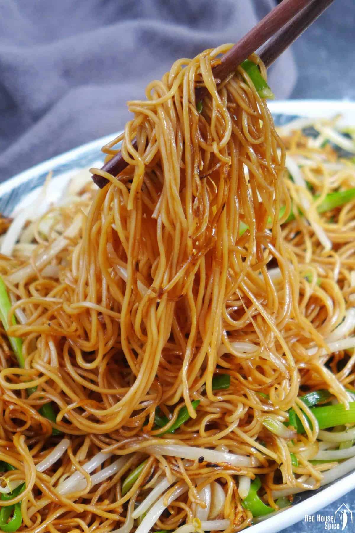 pulling noodles with chopsticks.