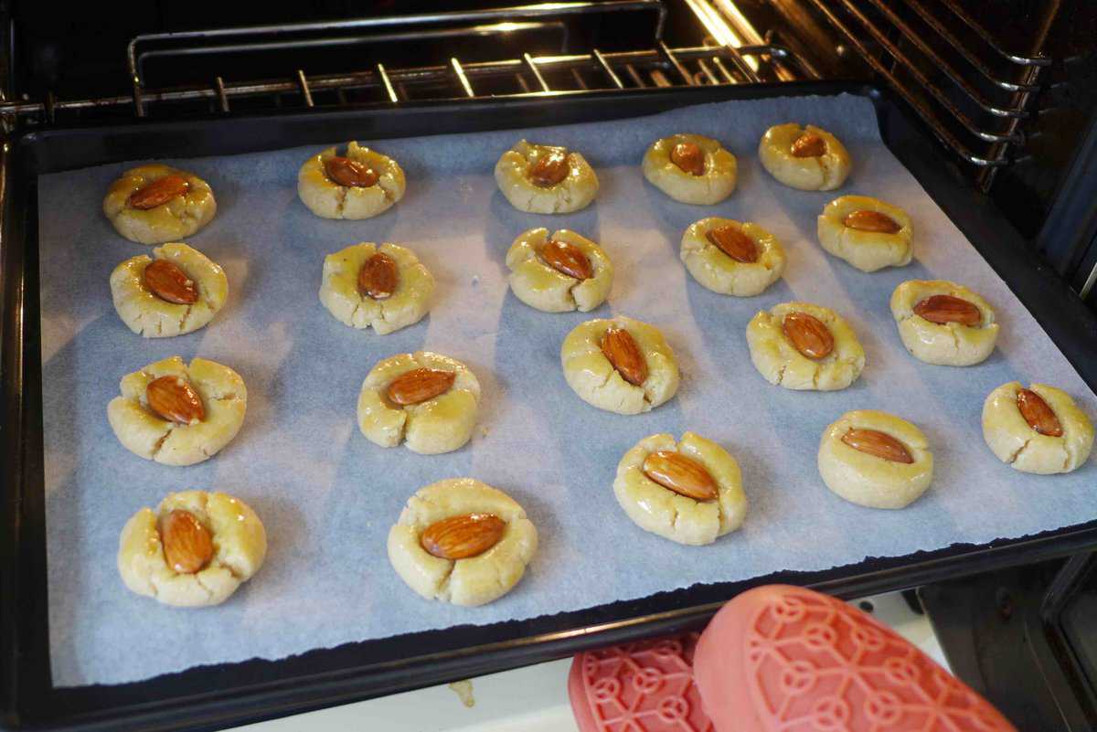 putting a tray of cookies into the oven.