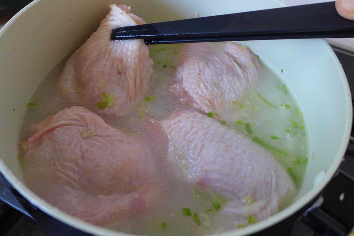 putting chicken thighs in to a pot