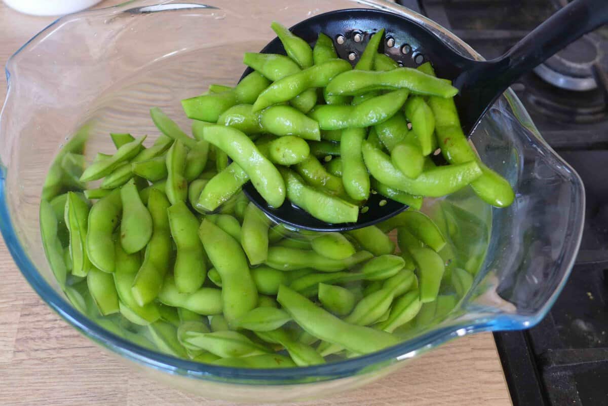 putting edamame into cold water.