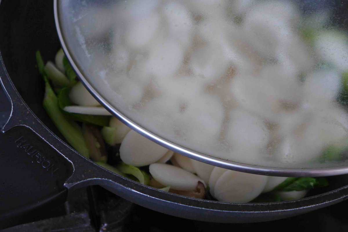 covering wok with a lid.
