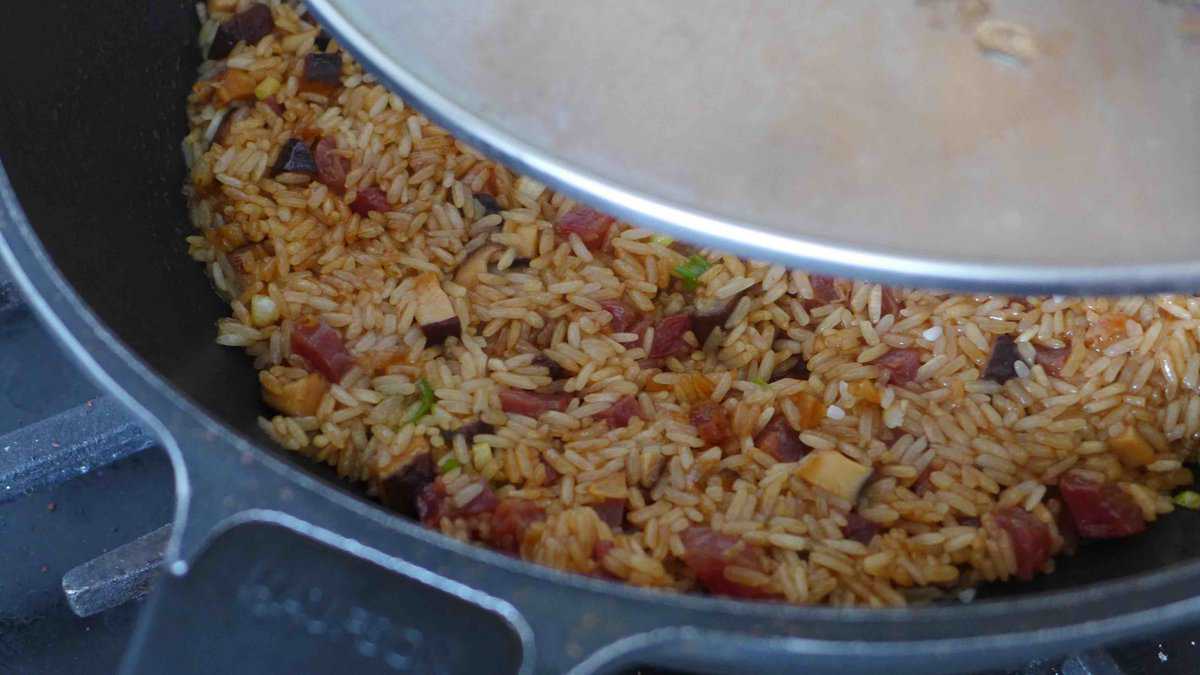 covering wok with a lid.