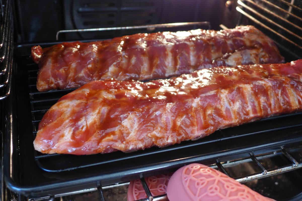 putting marinated ribs into the oven.