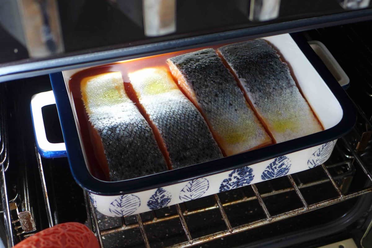 putting salmon filets into oven.