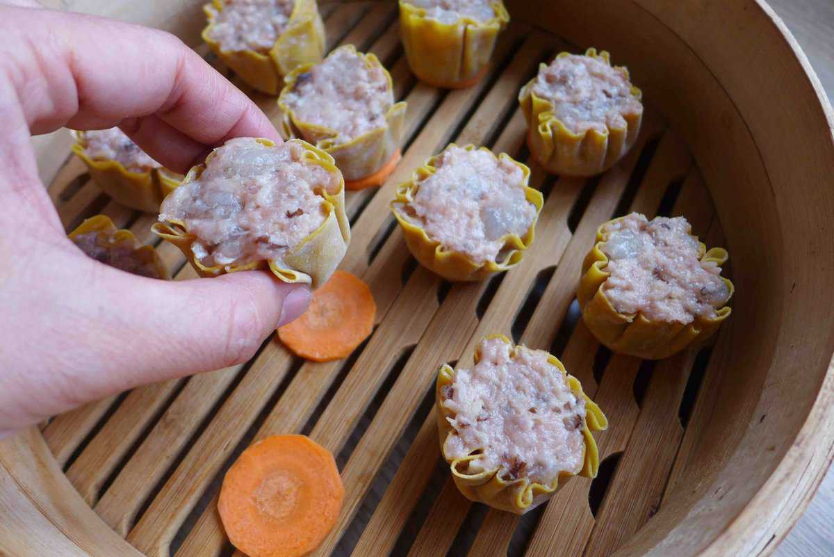 putting assembled Siu Mai over carrot slices.