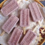 six red bean popsicles on a tray.