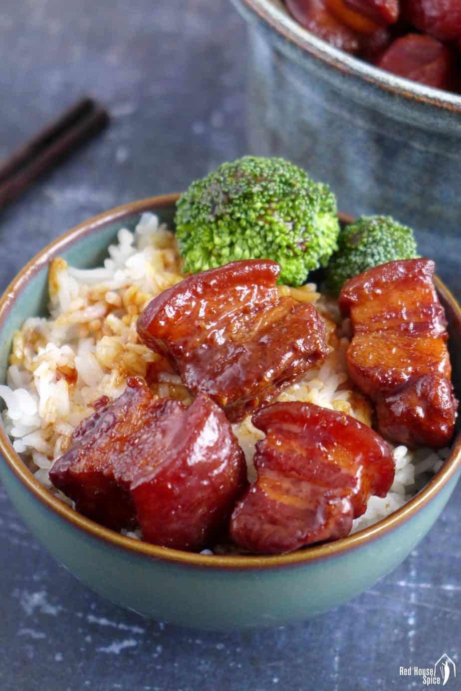 Red braised pork belly over a bowl of rice