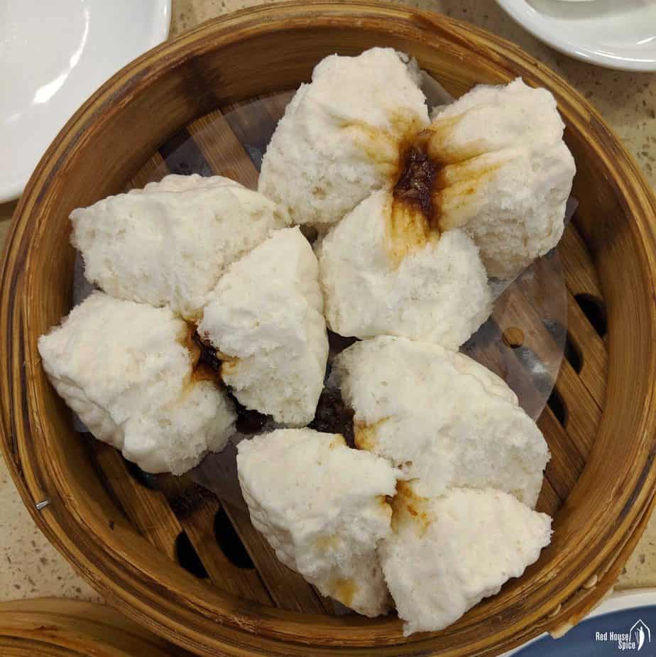 three restaurant style Char Siu bao in a bamboo basket