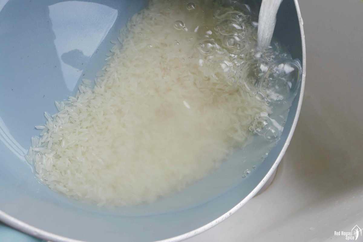 rinsing rice under running water