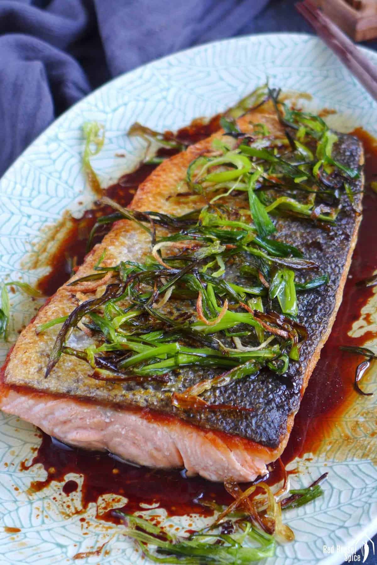 pan-fried salmon with fried scallions, ginger and a soy sauce dressing.