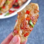 a chicken wing held by hand.