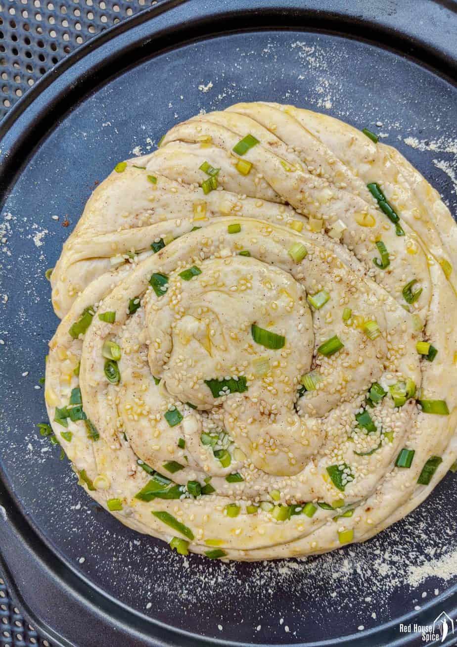 An uncooked scallion bread
