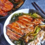 scallion chicken chops over steamed rice. with uncut chicken in skillet.