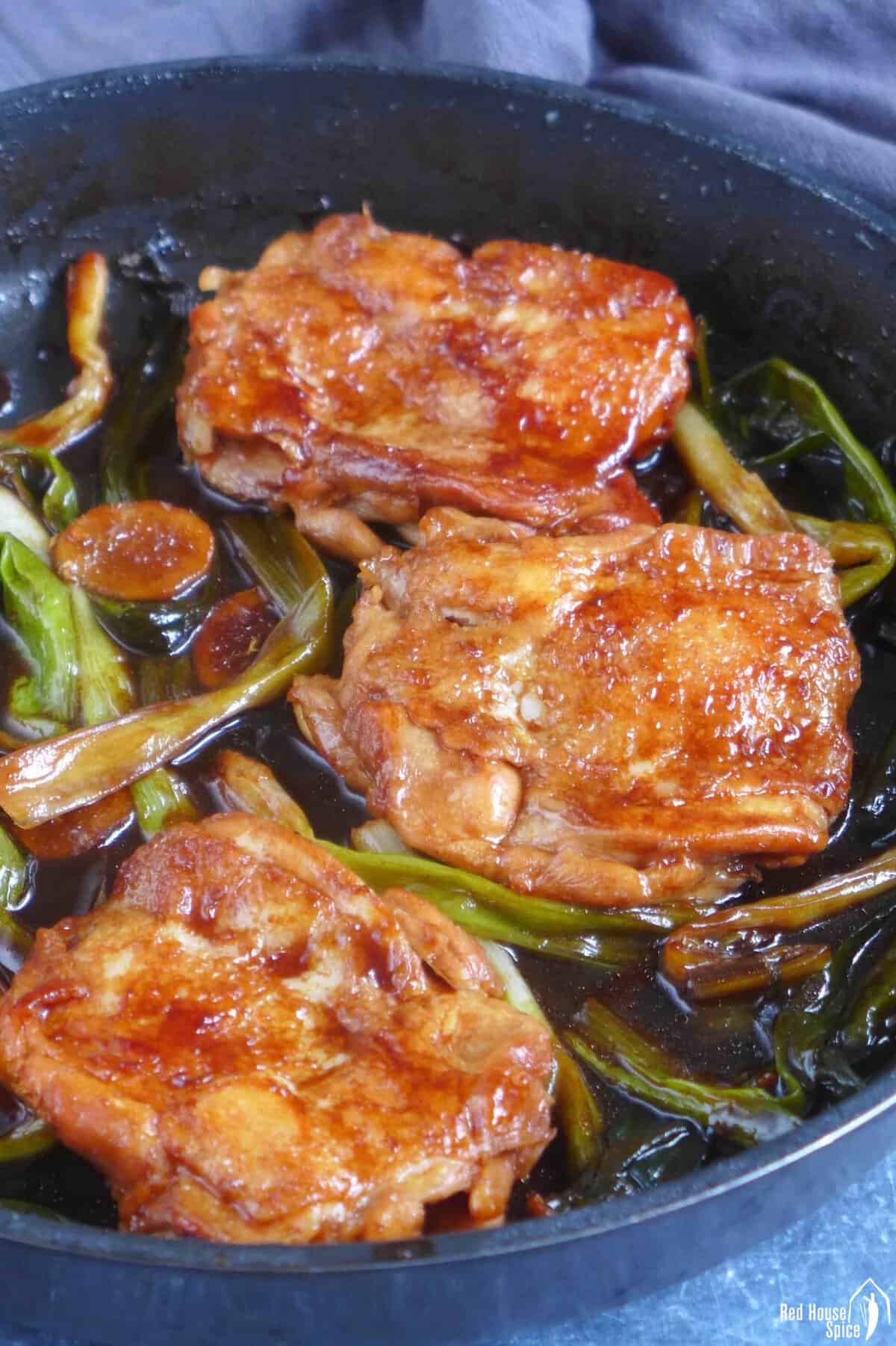 scallion chicken chops in skillet.