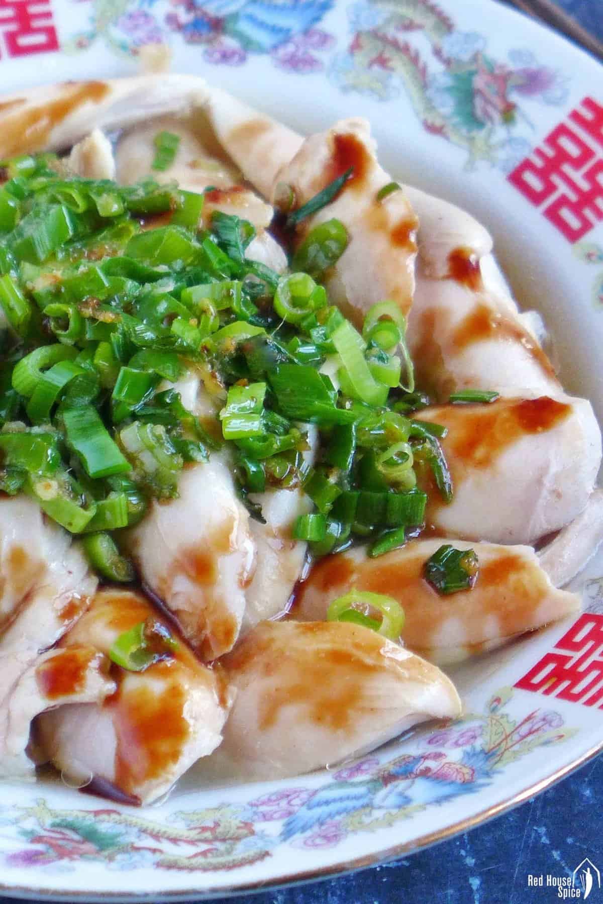 poached chicken with scallion oil and soy sauce.