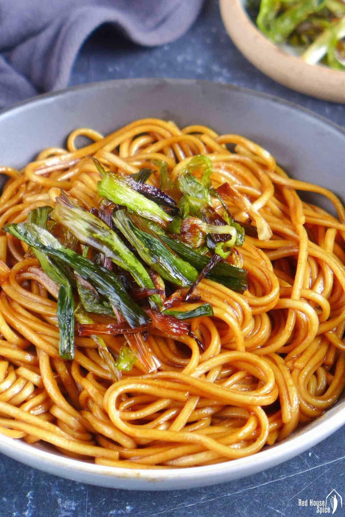 scallion oil noodles garnished with fried scallions.