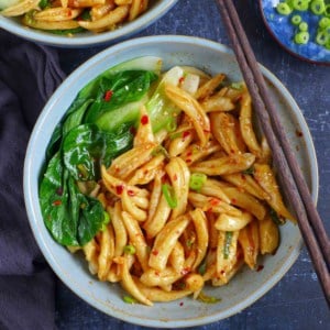 A bowls of scissor cut noodles with Bok Choy