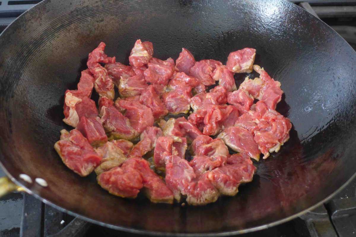 searing beef in a wok.