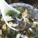 seaweed and egg soup in a spoon.